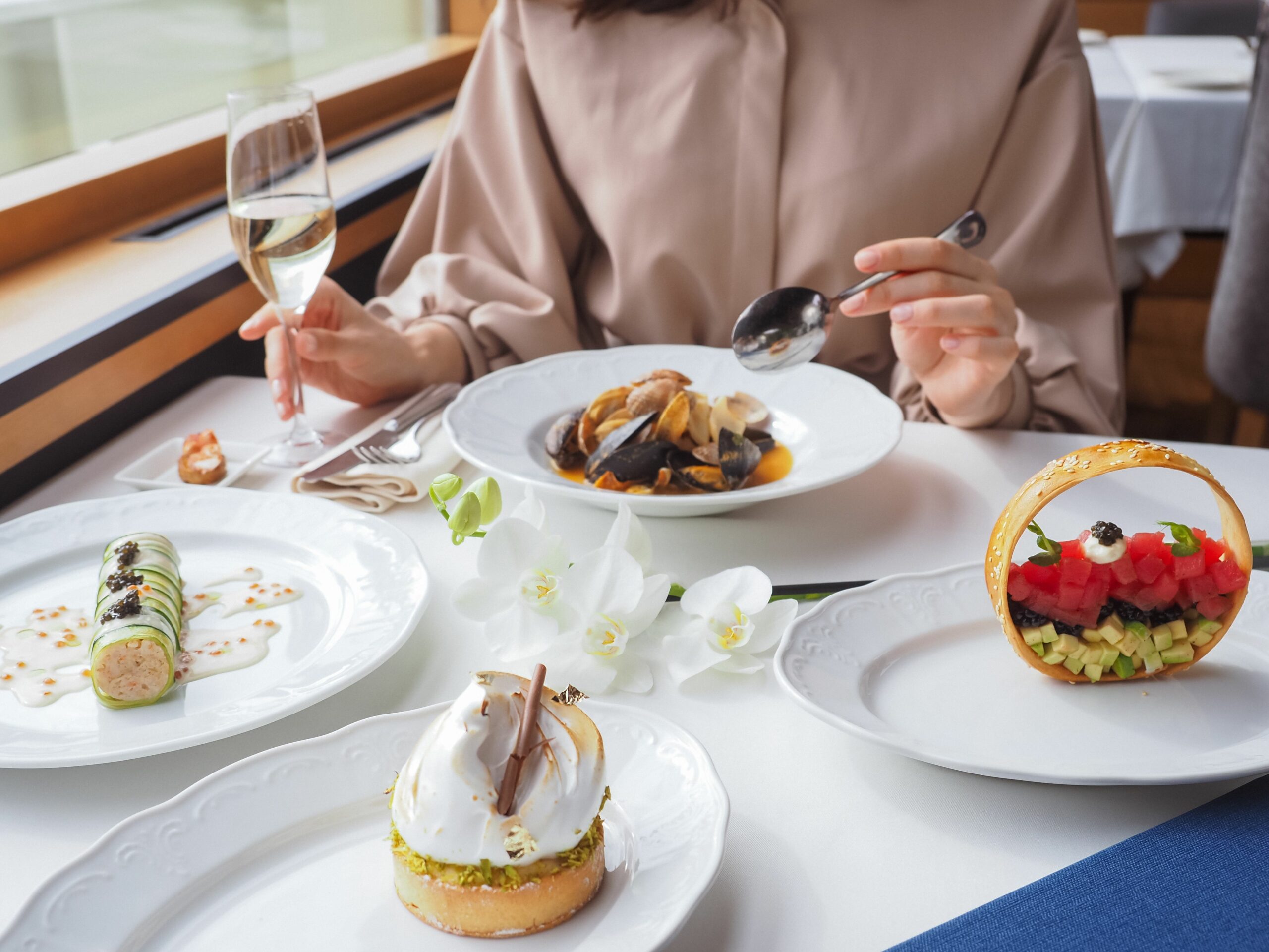 Luxurious gourmet dinner setting with diverse exquisite dishes and champagne.